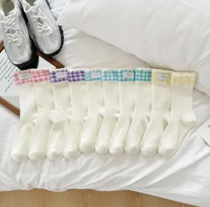 Cute cotton mid-tube socks featuring colorful checkered ruffles and delicate handmade tags.