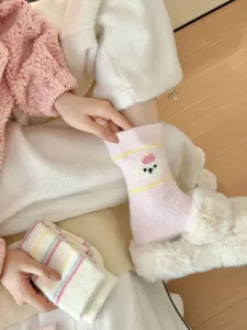 Cozy fuzzy winter thermal socks for women, cute plush mid-tube design, soft and warm daily wear.