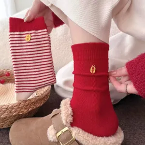 New year red mid-tube socks with auspicious metal charms, cozy knit warm hosiery for winter.