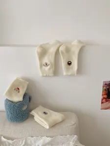 White fleece warm winter socks with cute cartoon embroidery, soft cozy floor socks for women.