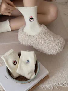 Cozy fleece wool socks detail with cute cartoon embroidery, warm winter home wear.
