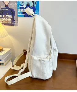 Minimalist student backpack detail showing side pocket, lightweight canvas rucksack for daily commute.