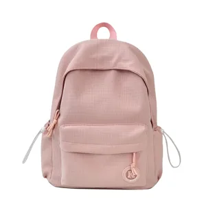 Pink textured casual school backpack with front pocket and convenient side drawstrings.