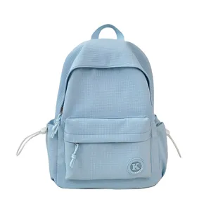 Light blue student backpack detail, textured grid fabric, front zipper pocket design.
