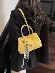 Elegante gelbe Ledertasche für Damen, schicke Umhängetasche mit süßem Anhänger für Alltag.