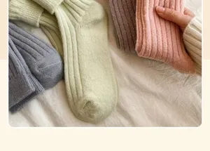 Close-up detail of soft ribbed winter socks in cozy pastel colors, warm knit fabric texture.