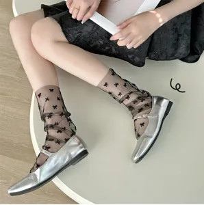Black sheer mesh socks with cute bow patterns paired perfectly with silver Mary Jane shoes.