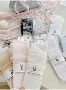 Sheer polka dot mesh mid-calf socks with ballet style packaging for women summer daily wear.