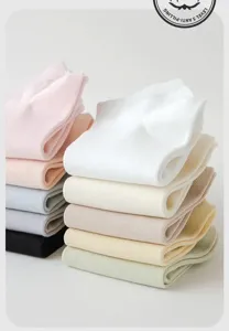 Dettaglio di calzini corti anti pilling da donna in cotone tinta unita impilati in tonalita pastello.