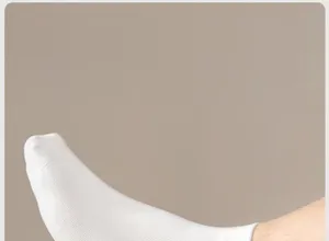 Close-up detail of solid white men's short cotton socks on foot, showing breathable texture.
