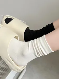 Detail shot of comfortable cotton mid-tube slouch socks, soft breathable fabric texture.