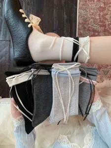 Close-up detail of women slouch socks featuring cute polka dot ribbon bows and ballet style.