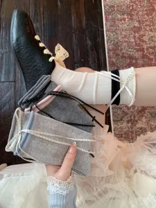 Detail shot of women cotton slouch socks with cute ribbon bow and ballet style design.
