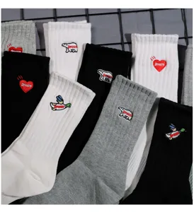 Detail view of trendy embroidered mid-calf socks with cute animal and heart patterns.