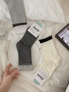 Comfortable solid color mid-tube socks with cute rolled cuffs for women, spring autumn wear.