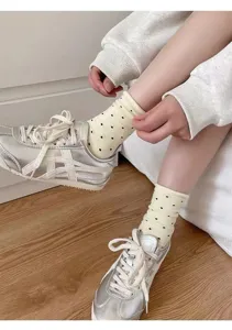 Cotton polka dot mid-tube socks for women, cute yellow stacked socks with rolled cuffs.