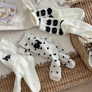 Detailed view of cute cartoon cat cotton mid-tube socks with polka dot patterns for women.