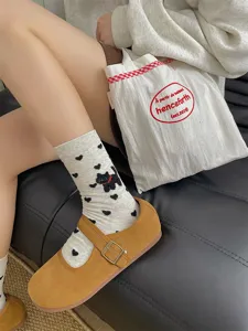 Detail shot of cute cat and heart pattern cotton mid-tube socks, soft daily wear style.
