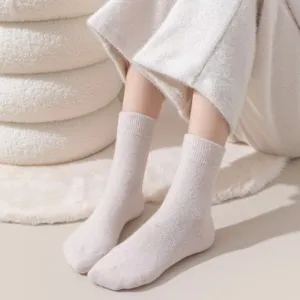 Close-up detail of cozy knitted wool socks in neutral beige, soft texture for winter.