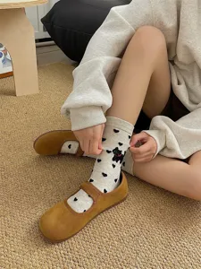 Cozy beige mid-calf socks featuring black heart patterns and cute animal embroidery details.