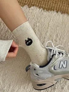 Cute black cat embroidered crew socks for women, soft spring dot yarn cotton mid-calf hosiery.