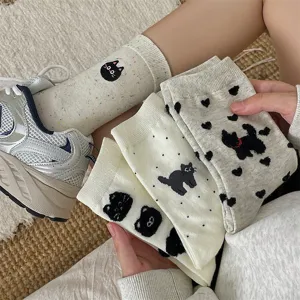 Close-up detail of cute cartoon cat and heart pattern mid-tube cotton socks for women spring.