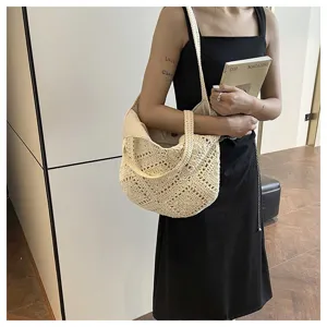 Minimalist woven straw shoulder tote bag for women, stylish beach vacation handbag.