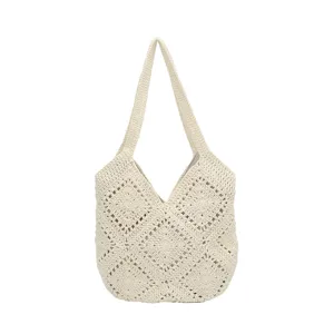 Detailed view of handmade crochet shoulder tote bag with vintage geometric pattern in beige color.