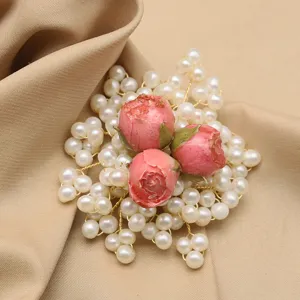 Elegant handmade pearl rose brooch with gold wire, vintage style floral jewelry accessory.
