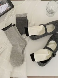 Stylish women's mid-calf socks and vintage gray mary jane shoes set for daily wear.