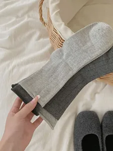 Close-up detail shot of women's ribbed mid-tube socks in grey, cozy daily style.