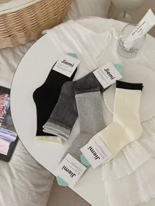 Classic solid color mid-calf socks set with rolled cuffs, perfect for casual autumn outfits.