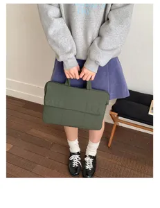 Detailed view of a padded green quilted laptop bag, perfect for daily commuting and office.