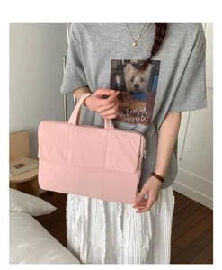 Pink quilted laptop bag for women, thick padded commuter handbag for daily office and school use.