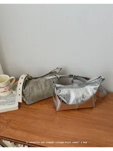 Detailed view of versatile vintage-style women shoulder bags in silver and khaki colors.