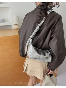 Silver metallic shoulder bag for women, vintage motorcycle style hobo bag with zipper details.