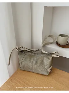 Detailed shot of vintage canvas shoulder bag with leather trim, stylish daily accessory.