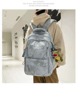 Casual nylon backpack detail shot showing print pattern, durable fabric and cute dinosaur charm.