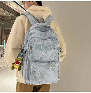 Casual large capacity nylon school backpack with trendy doodle print and cute dinosaur pendant.