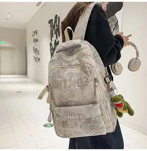 Minimalist nylon school backpack with graffiti print and large letter embroidery for daily use.