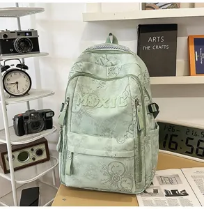 Detailed view of the stylish green nylon backpack featuring multi-pocket design and graffiti prints.