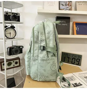 Detail shot of green nylon campus backpack with graffiti patterns and side buckle, side view.
