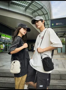 Details of the casual minimalist drawstring bucket bag worn in street style, showing design features.