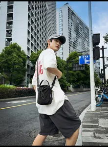 Casual minimalist black drawstring bucket bag for women, stylish nylon crossbody shoulder bag.