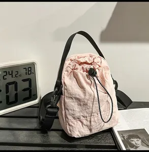 Casual candy color drawstring bucket bag detail showing soft nylon fabric and shoulder strap.
