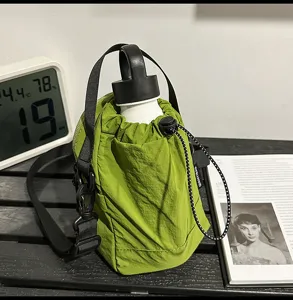 Green drawstring bucket bag for women, casual nylon water bottle shoulder bag with strap.