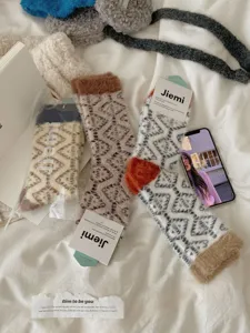 Cozy coral fleece winter mid-tube socks for women, thick plush home sleep socks detail view.