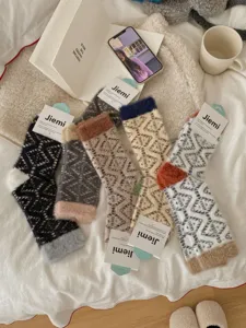 Fluffy coral fleece women socks detail, showing soft texture and cozy geometric patterns for home.