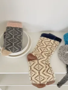 Cozy coral fleece fuzzy winter socks with classic geometric pattern, thick and warm for home use.