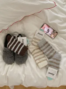 Detail view of thick warm wool socks and cozy slippers for women, ideal for winter.